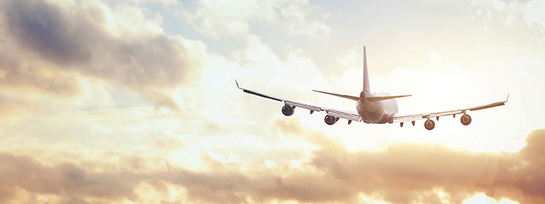 airplane in sunset sky
