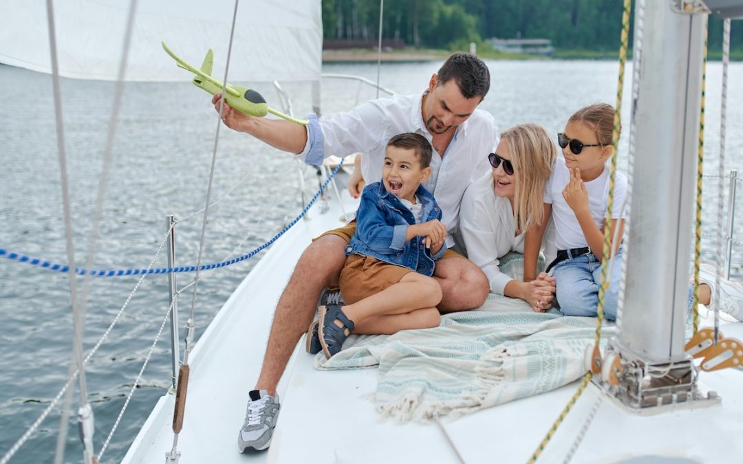 happy family on sailboat in sea