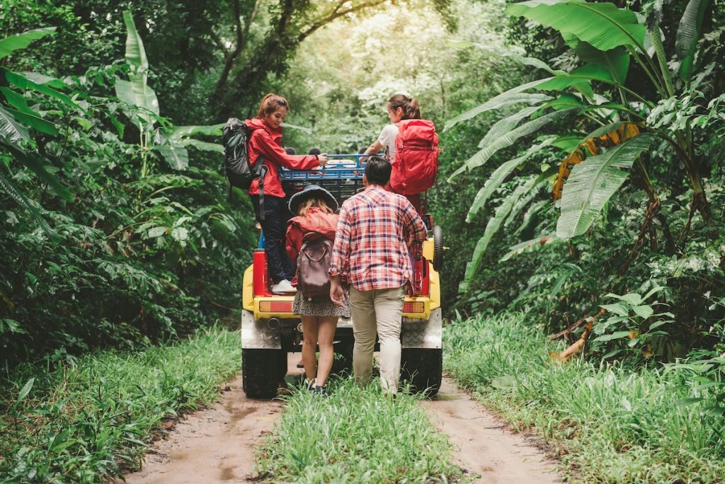Family behind a yellow SUV